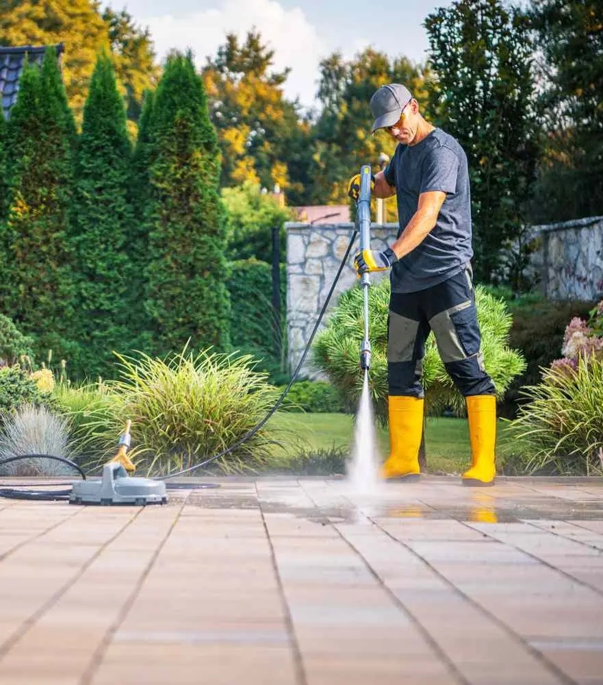 Pressure washer cleaning a driveway